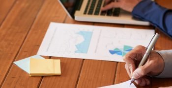 Close-up image of entrepreneur checking document before signing